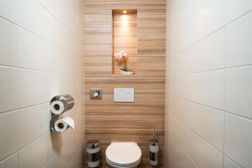 a small bathroom with a toilet and a sink at Leonardo Hotel Vienna Hauptbahnhof in Vienna