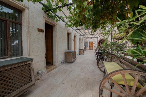 an empty hallway with tables and chairs in a building at Roma Cave Suite in Goreme