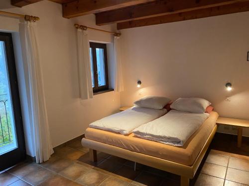 a bedroom with a bed in a room at Osteria Vittoria in Lavertezzo