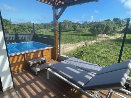 a patio with a swimming pool and a table and chairs at Ti-Kaz Gwada Le Gosier in Le Gosier