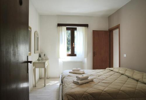 a bedroom with a bed with towels on it at Hotel Al Verde in Mandello del Lario