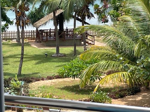 a view from a window of a resort with palm trees at Beach Bliss in Trincomalee