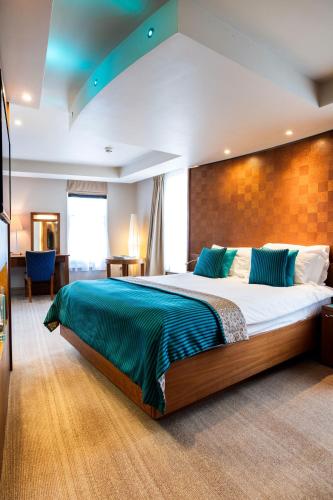 a bedroom with a large bed in a room at The Royal Yacht in Saint Helier Jersey