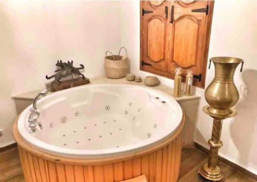 a large bath tub in a bathroom with at Dar Youssef Medina Sousse in Sousse