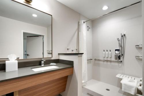 a white bathroom with a sink and a shower at Fairfield by Marriott Inn & Suites Salt Lake City Cottonwood in Holladay