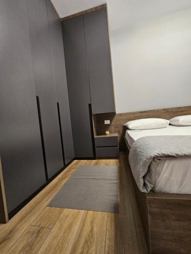 a bedroom with a bed and a rug at Tirana Apartment KDK in Tirana