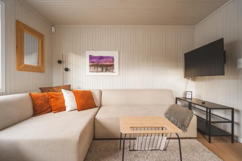 a living room with a couch and a table at Little White House in Reine