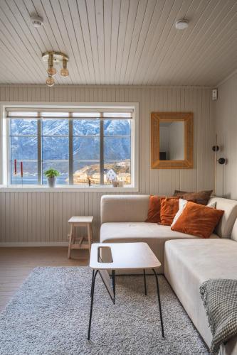 a living room with a couch and a table at White House - Panoramic View in Reine