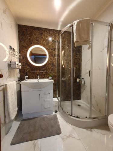 a bathroom with a shower and a sink at Grandview Melbourne Executive 2BR Apartment in Melbourne
