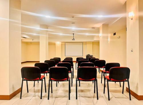 a conference room with chairs and a whiteboard at Hotel O Guerreiro in Ponte da Barca