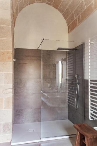 a shower with a glass door in a bathroom at Le Vie Del Centro Luxury Room in Matera