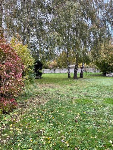 a park with trees and a field of grass at Le Duo de la forêt in Sahurs