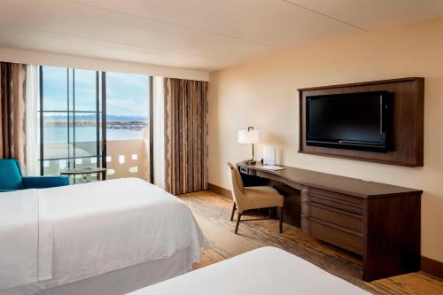 a hotel room with a bed and a desk with a television at The Westin Lake Las Vegas Resort & Spa in Las Vegas