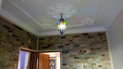 a stained glass chandelier hanging from a ceiling at Mirleft Tayought Guest House in Mirleft
