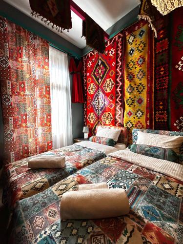 a bedroom with two beds with colorful walls at Hotel Zerta Old Tbilisi in Tbilisi City