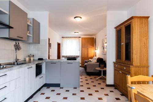 a kitchen with white cabinets and a table at [Centro-Storico] Tutto a 2 passi in Rapallo