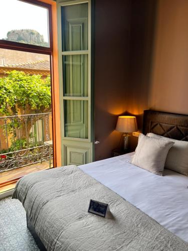 a bedroom with a bed with a book on it at La Indiana de Begur, Petit Hotel Boutique in Begur