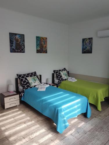 a bedroom with two beds with a blue comforter at Apartament Angelo in Sosnowiec