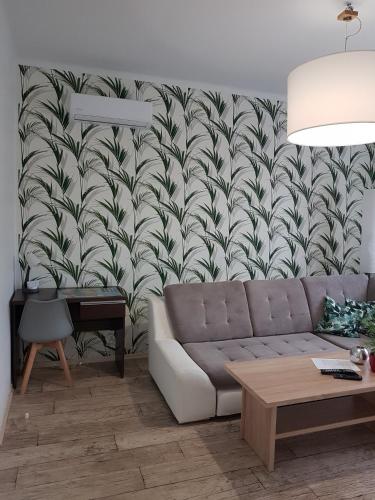 a living room with a couch and a wall mural at Apartament Angelo in Sosnowiec