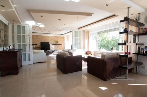 a large living room with a couch and chairs at Sweet House Parlament Lux in Belgrade
