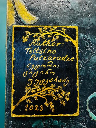 a sign with a tree on the ground at Hotel Zerta Old Tbilisi in Tbilisi City