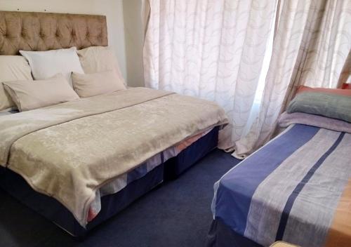 Un ou plusieurs lits dans un hébergement de l'établissement NSK GUEST HOUSE