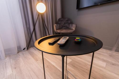 a table with two remote controls and a chair at LUX Апартаменти MYFREEDOM поруч метро Театральна, Хрещатик in Kyiv