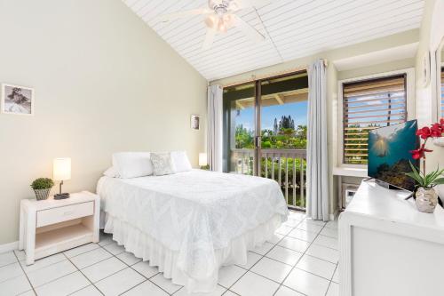 a white bedroom with a bed and a balcony at Ilima West Kuilima Estates 18 At Turtle Bay in Kahuku