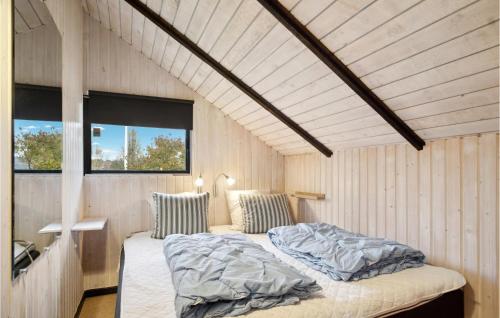 een slaapkamer met een bed in een kamer met houten wanden bij Awesome Home In Hejls With Wifi in Hejls