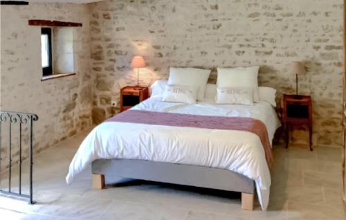 a bedroom with a large bed with white sheets and pillows at Stunning Home In Prailles With Outdoor Swimming Pool in Prailles