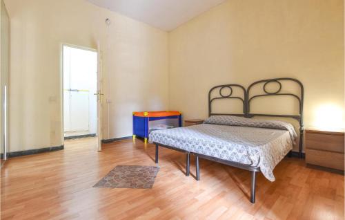 a bedroom with a bed and a wooden floor at 1 Bedroom Pet Friendly Apartment In Acireale in Acireale