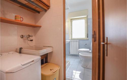 a small bathroom with a sink and a toilet at Amazing Apartment In Piedimonte Etneo With 2 Bedrooms And Wifi in Piedimonte Etneo