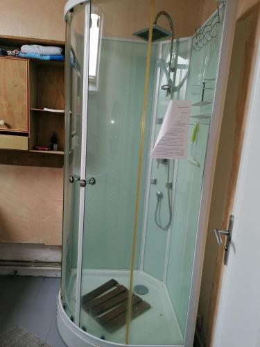 um chuveiro com uma caixa de vidro na casa de banho em L'Atelier em Lannion