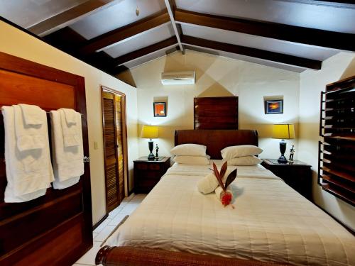 a bedroom with a bed with a flower on it at Yocamatsu in Caye Caulker