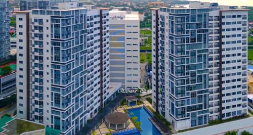an aerial view of tall buildings in a city at Mactan Newtown - New Modern Condo with Ocean View in Mactan