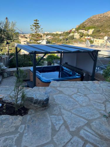 a hot tub with a blue cover on a patio at ISTRON BREEZE II in Istron
