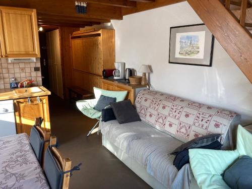 a living room with a couch in a kitchen at Appartement dupleix - 6 personnes - Grand Bornand village in Le Grand-Bornand
