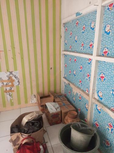 a corner of a room with boxes on the floor at Permata homestay in Karawang