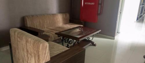 a waiting room with two chairs and a table at Permata homestay in Karawang