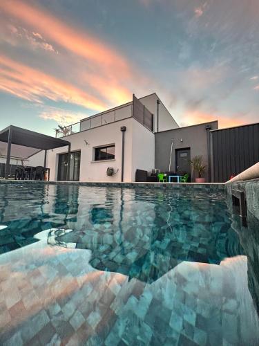 une piscine devant une maison dans l'établissement Maison contemporaine en plein cœur de la Touraine, à Chambray-lès-Tours