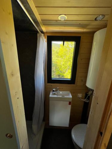 a small bathroom with a sink and a window at Petit chalet Cosy in Villard-de-Lans