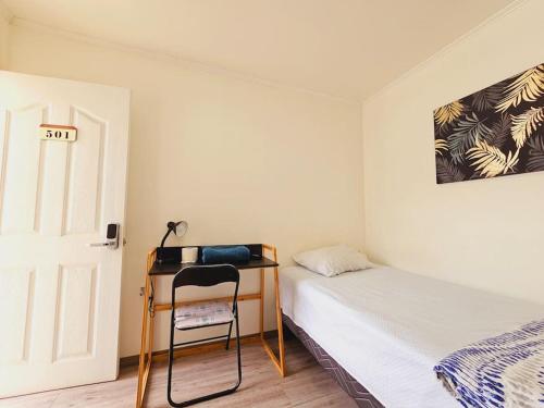 een kleine slaapkamer met een bureau en een bed bij Alojamiento Privado 502 en Antofa in Antofagasta