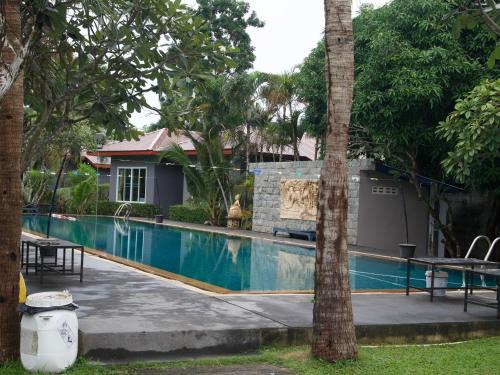 a swimming pool in front of a house at Mindful Kinesics Wellness Living in Nathon Bay
