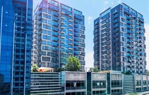 two tall buildings in a city with buildings at Mactan Newtown - 1BR Stunning Ocean View and City View in Mactan