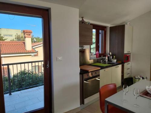 a kitchen with a view of a balcony at Hiša Kontovel in Trieste