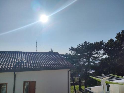 a light on the roof of a white house at Hiša Kontovel in Trieste