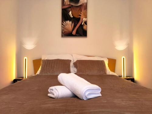 a bedroom with a bed with two towels on it at CozyHome Medena Central, quiet premium spot in Old Town in Bratislava