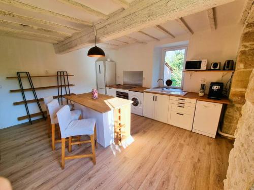 eine Küche mit einem Tisch und Stühlen im Zimmer in der Unterkunft Le Cottage 