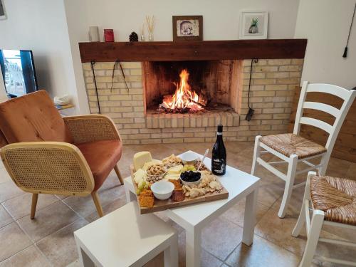 a table with a tray of food and a fireplace at DaVi' casa vacanze. Un sogno immerso nel verde ! in Montepagano