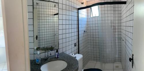 a bathroom with a sink and a toilet at Edifício Ocean garden in São Luís